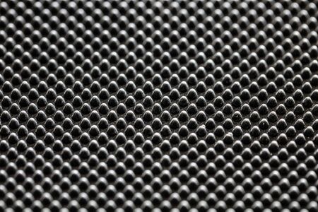 Black bumpy rubber surface used as a background. Black and white texture of rubber material with...