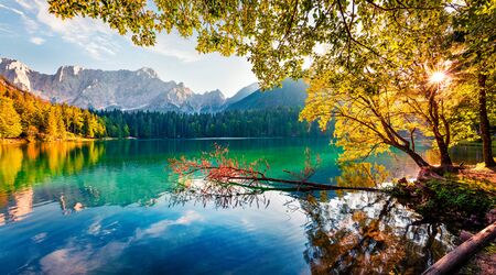 On the boder with Slovenia located two fantastic lake - Fusine Superiaore and Fusine Inferiore. Bright morning scene of Julian Alps with Mangart peak on background, Province of Udine, Italy.の写真素材
