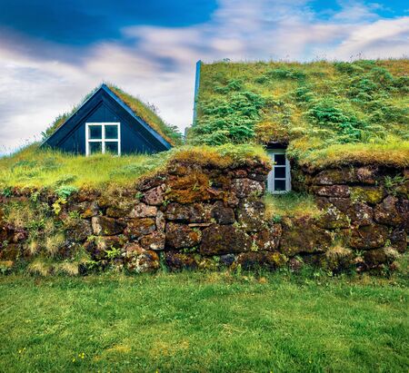 Typical view of Icelandic turf-top houses. Picturesque summer morning in the Skogar village, south Iceland, Europe. Beauty of countryside concept background.の写真素材