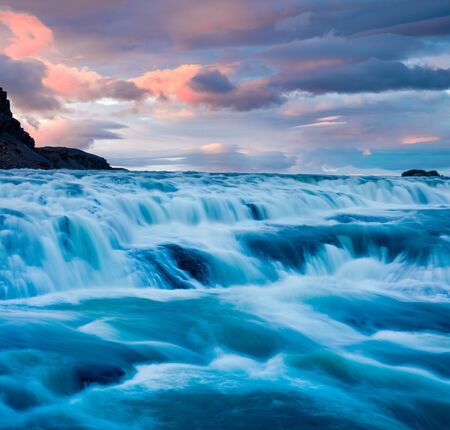 Stunning summer sunrise on of Gullfoss - popular tourist destination. Amazing morning view of Hvita...