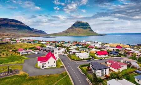 View from flying drone. Splendid morning cityscape of Grundarfjordur town with Kirkjufell Mountain on background. Aerial view of Grundarfjordur Church, Iceland, Europe. Traveling concept background.の写真素材