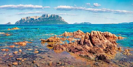 Panoramic spring view of Tavolara island from Spiaggia del dottore beach. Marvelous morning scene of Sardinia island, Italy, Europe. Sunny Mediterranean seascape. Beauty of nature concept backgroundの写真素材
