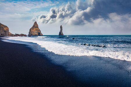 Amazing afternoon seascape of Atlantic ocean. Black sand beach and Reynisdrangar cliffs. Dramatic ...