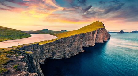 View from flying drone. Astonishing morning scene of Sorvagsvatn lake, Vagar, Faroe Islands, Denmark, Europe. Amazing summer sunrise on Atlantic Ocean.の写真素材