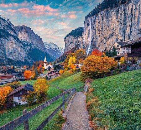 Magnificent autumn view of great waterfall in Lauterbrunnen village. Superb outdoor scene in Swiss Alps, Bernese Oberland in the canton of Bern, Switzerland. Beauty of countryside concept background.の写真素材