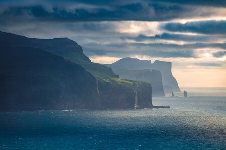 Dramatic summer view of popular tourist attraction - Risin og Kellingin cliffs. Gloomy morning scene of Eysturoy island, Atlantic ocean, Faroe Islands, Denmark, Europe. Traveling concept background.
の写真素材