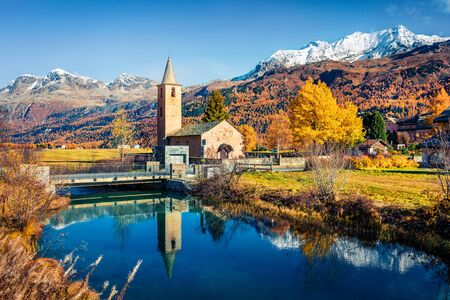 Perfect autumn view of San Lurench church in Sils im Engadin village. Stunning morning scene of...