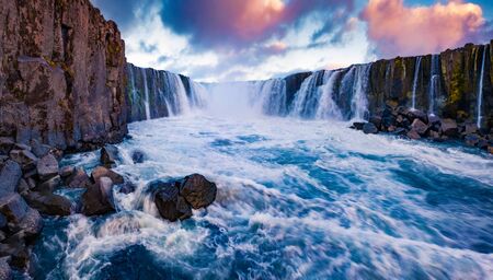 View from the down of canyon of Selfoss Waterfall. Fantastic evening scene of Jokulsa a Fjollum river, Jokulsargljufur National Park. Breathtaking sunrise in Iceland, Europe. の写真素材
