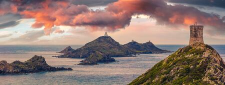 Panoramic summer view of popular tourist destination Torra di a Parata - 16th-century Genoese tower reached by a rocky nature trail, Corsica island, France, Europe.の写真素材