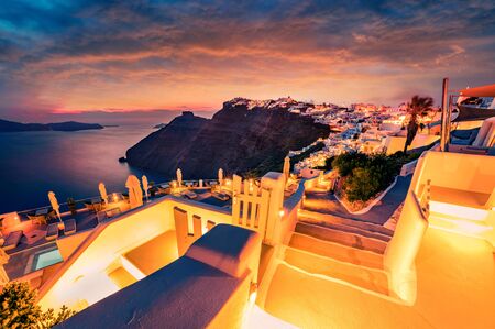 Unbelievable summer sunset on famous Greek resort Fira, Greece, Europe. Dramatic evening view of Santorini island. Magnificent Mediterranean landscape. Traveling concept background.の写真素材