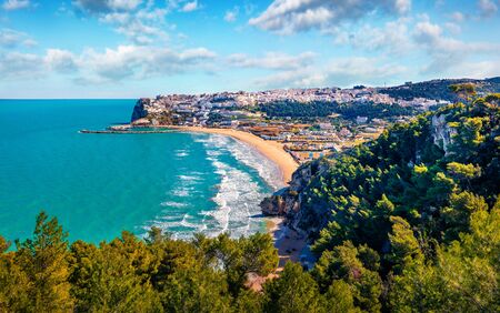 View from flying drone. Sunny summer cityscape of Peschici town, Province of Foggia, Italy, Europe. Brighjt morning seascape of Adriatic sea. Top down view. Traveling concept background.の写真素材