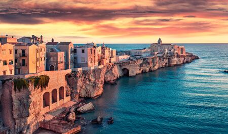 Impressive evening cityscape of Vieste - coastal town in Gargano National Park, Italy, Europe. Fantastic summer sunset on Adriatic sea. Traveling concept background.の写真素材