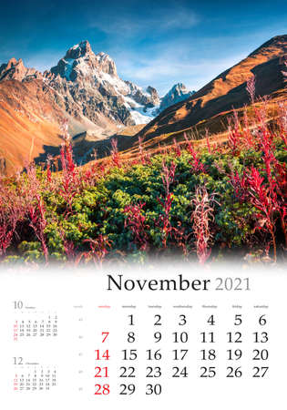 Calendar November 2021, vertical B3 size. Set of calendars with amazing landscapes. Colorful autumn morning in Caucasus mountains with Ushba peak, Upper Svaneti, Main Caucasus ridge, Georgia.の写真素材