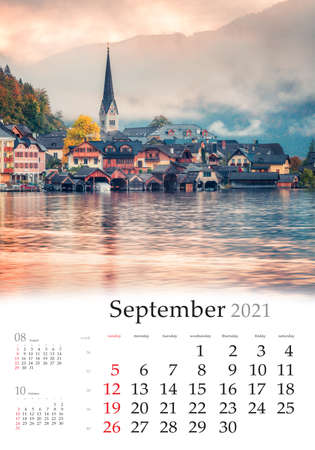 Calendar September 2021, vertical B3 size. Set of calendars with amazing landscapes. Foggy autumn sunrise on Hallstatt lake. Spectacular morning view of Hallstatt village, Austria, Europe.の写真素材
