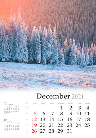 Calendar December 2021, vertical B3 size. Set of calendars with amazing landscapes. Marvelous morning after snowfall in mountain forest. Wonderful winter sunrise in Carpathians, Ukraine.の写真素材