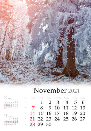 Calendar November 2021, vertical B3 size. Set of calendars with amazing landscapes. First frost in the mountain forest. Calm morning scene of the Carpathian mountains, Ukraine, Europe.の写真素材