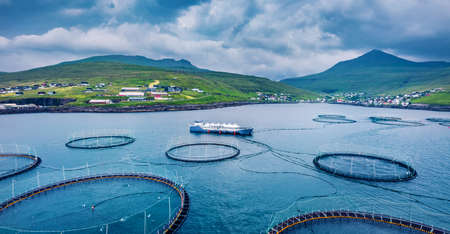 View from flying drone. Trout farm nearby Sandavagur village. Gloomy summer scene of Vagar island. Panoramic morning view of Faroe Islands, Denmark, Europe. Traveling concept background.の写真素材