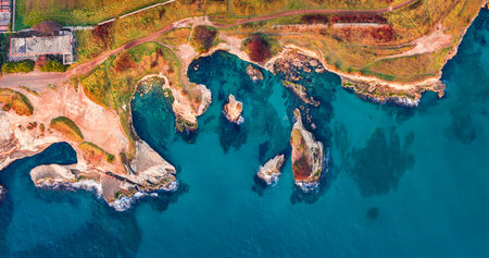 Straight-down view from flying drone of popular tourist attraction - Torre Sant'Andrea. Stunning morning seascape of Adriatic sea, Torre Sant'Andrea village location, Apulia region, Italy, Europe.の写真素材