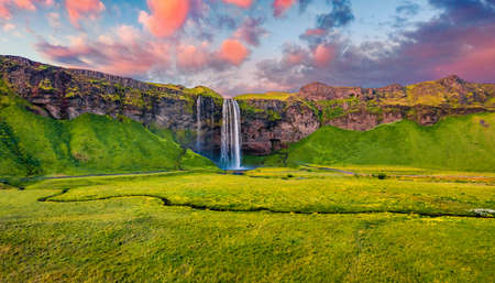 View from flying drone. Attractive summer view of Seljalandsfoss waterfall. Captivating sunrise in Iceland, Europe. Freat outdoor scene. Beauty of nature concept background.の写真素材