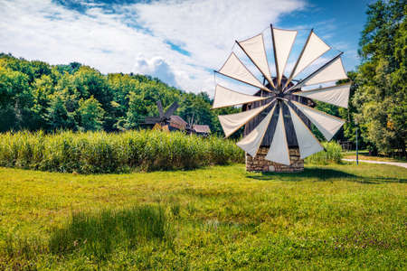 Spectacular summer view of traditional romanian windmill. Perfect rural scene of Transylvania,...