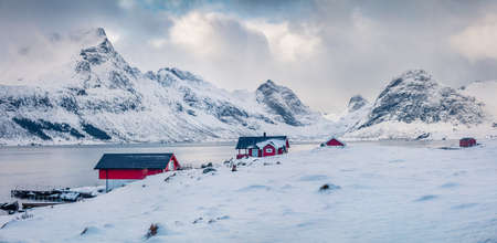 Misty morning view of Krystadveien village on the Sandvika bay. Snowy winter scene of Lofoten Islans, Norway, Europe. Frosty panoramic seascape of Norwegian sea. Life over polar circle.の写真素材