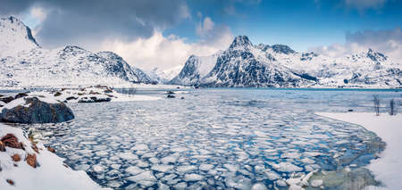 Incredible winter scene over polar circle. Frozen Boosen fjord on Flakstadoya island. Panoramic morning view of Lofoten islands with Hustinden mountain on background, Norway, Europe.の写真素材
