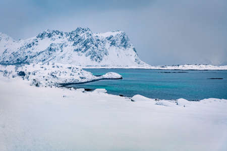 Calm winter scene of Vestvagoy island. Snowy mountain peak on Lofoten Islands, after huge snowfall....