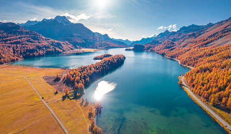 Sun reflected in the calm waterf of Sils lake. Exciting autumn scene of Swiss Alps. Wonderful...