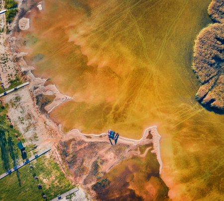 aerial landscape photography. Straight down view from flying drone of shore and fishing boats on Svityaz lake. Sunny summer scene of Shatsky National Park, Volyn region, Ukraine, Europe.の写真素材