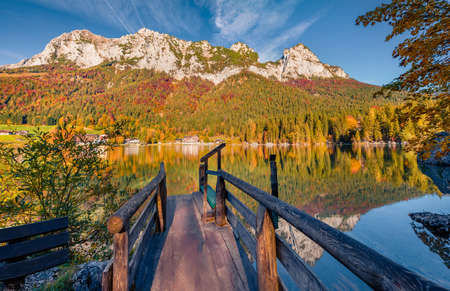 Old wooden pier on Hintersee lake. Picturesque morning scene of Bavarian Alps on the Austrian...