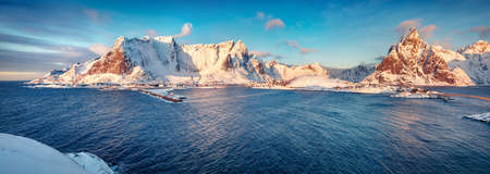 Panoramic morning cityscape of Reine town. Gorgeous view of Lofoten Island with Reinebringen peak on...