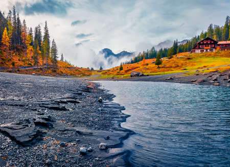 Gloomy morning scene of Oeschinensee Lake. Amazing autumn view of Swiss Alps. Splendid landscape of Switzerland, Europe.Beautiful autumn scenery.の写真素材