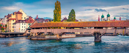 Panoramic morning view of Spreuer Bridge and Jesuitenkirche Church on background. Attractive autumn cityscape of Lucerne, Switzerland, Europe. Travel concept background.の写真素材