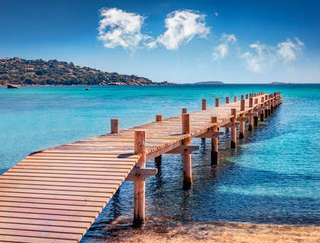 Stunning summer view of wooden pier on Santa Giulia beach. Sunny morning scene of Corsica island, France, Europe. Attractive Mediterranean seascape. beautiful summer scenery.の写真素材