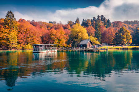 Beautiful Croatian scenery. Excursion ships on the lake. Attractive autumn view of Plitvice lake. Colorful morning landscape of Croatia, Europe. Travel concept background.の写真素材