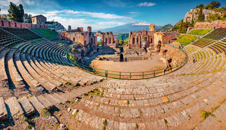 Spectacular morning view of Taormina town and Etna volcano on background. Gorgeous spring scene of ancient Greco-Roman theater, Sicily, Itale, Europe. Travel concept background.の写真素材