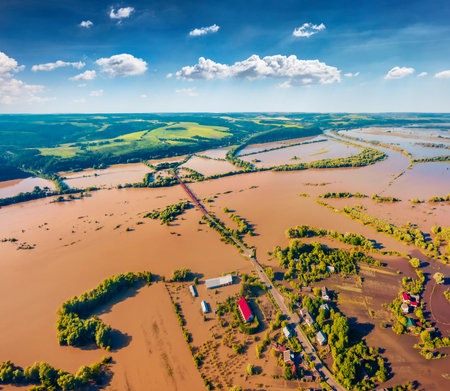 Flooded villages in western Ukraine. Flood on the Dniester River. View from flying drone of Nyzhniv village after a few days of huge rain. Disaster concept background. Flooded fields and farmhouses.の写真素材