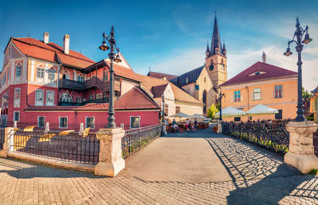 Charm of the ancient cities of Europe. Captivating evening view of Lutheran Cathedral of Saint Mary. Stunning summer cityscape of Sibiu town, Transylvania, Romania, Europe.の写真素材
