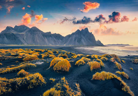 beautiful autumn scenery. Amazing view from flying drone of black sand dunes on Stokksnes cape with Vestrahorn (Batman Mountain) on background. Impressive morning scene of Iceland, Europe.の写真素材