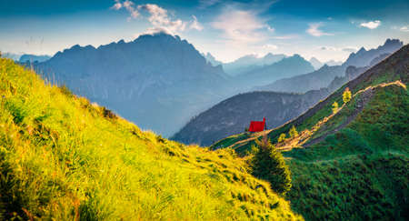 Fresh green view of Lastoni di Formin mountain range from Passo di Giau. Breathtaking summer scene of Dolomite Alps with red roof wooden chalet, Cortina d'Ampezzo location, South Tyrol, Italy.の写真素材