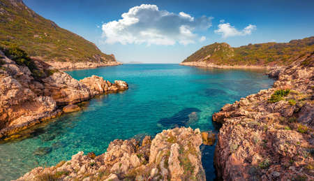 beautiful marine scenery. Rocky summer scene of Pirates Bay, Porto Timoni, Afionas village location. Amazing morning seascape of Ionian Sea. Colorful outdoor scene of Corfu island, Greece, Europe.の写真素材