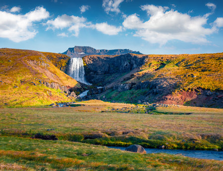 beautiful autumn scenery. Wonderful morning scene of Svodufoss waterfall. Majestic autumn view of Iceland, Europe. Beauty of nature concept background.の写真素材