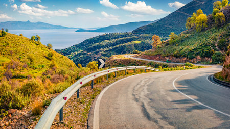 Typical Albanian view of Adriatic shore with empty asphalt road. Picturesque summer day in Albania, Europe. Travel concept background.の写真素材