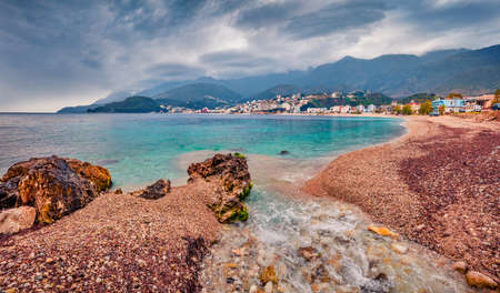 Gloomy spring view of Potam Public beach. Colorful morning seascape of Adriatic sea. Stunning cityscape of Himare town, Albania, Europe. Travel concept background.の写真素材
