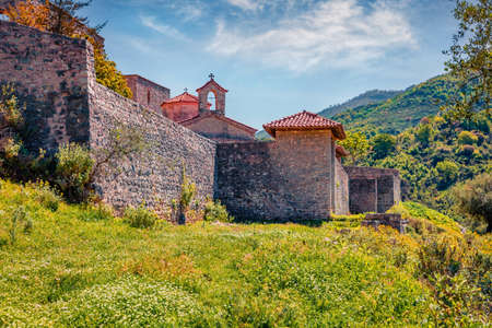 Abandoned St. Mary Monastery among fresh green forest. Stunning morning scene of Albania, Europe. Travel concept background.の写真素材