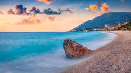 Spring sunrise in Dhermi town. Calm morning seascape of the Adriatic sea with endless horizon....