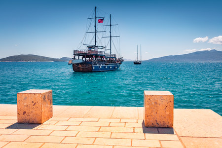 Wooden ship on the shore of Saranda port. Bright spring seascape of Ionian sea. Picturesque morning scene of Albania, Euroepe. Travel concept background.のeditorial素材