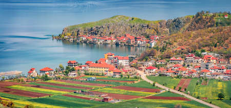 Panoramic spring cityscape of Lin town. Sunny morning scene of Ohrid lake. Picturesque outdoor scene of Albania, Europe. Travel concept background.の写真素材