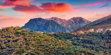 Typical Albanian view of Adriatic shore with small village on the hill. Picturesque summer sunrise in Albania, Europe. Travel concept background.の写真素材
