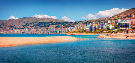 Azure river flowing in the sea. Panoramic spring cityscape of Saranda port. Amazing Ioninan seascape. Colorful morning scene of Albania, Europe. Travel concept background.の写真素材